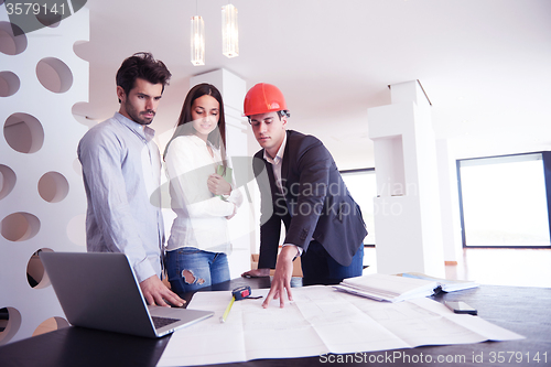 Image of couple buying new home with real estate agent