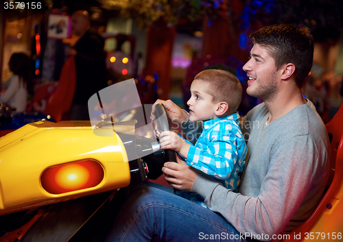 Image of father and son playing game in playground