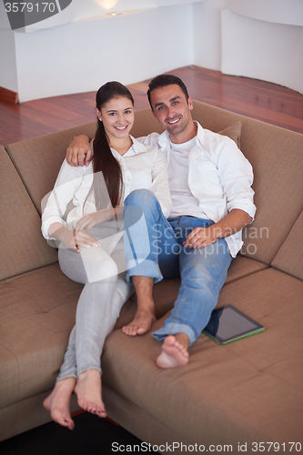Image of couple at modern home using tablet computer