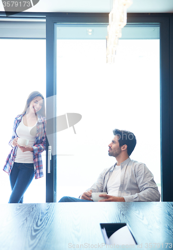 Image of relaxet young couple drink first morning coffee