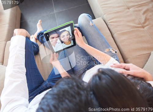 Image of couple at modern home using tablet computer