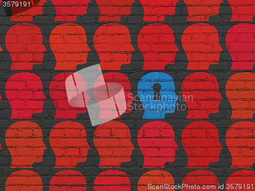 Image of Education concept: head with keyhole icon on wall background