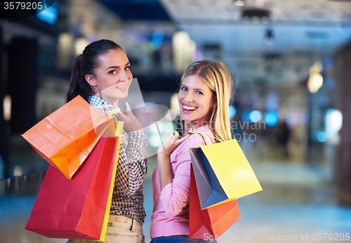 Image of happy young girls in  shopping mall