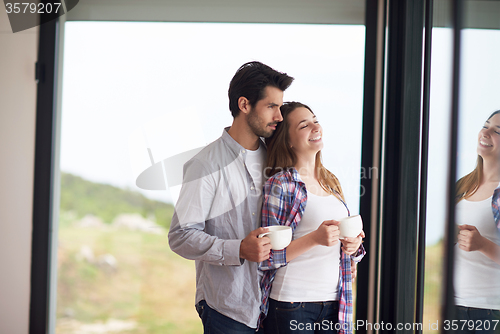 Image of relaxet young couple drink first morning coffee