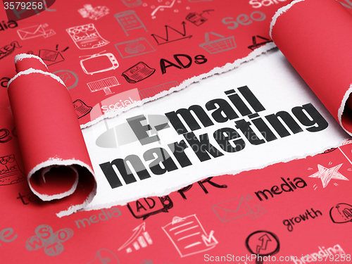 Image of Advertising concept: black text E-mail Marketing under the piece of  torn paper