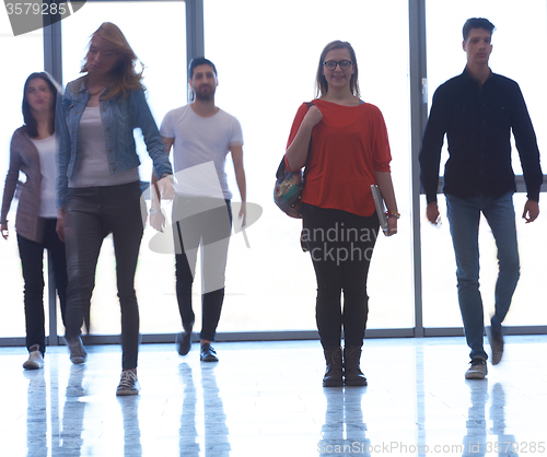 Image of student girl standing with laptop, people group passing by