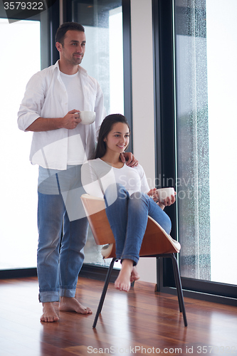 Image of relaxet young couple drink first morning coffee