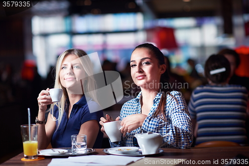 Image of girls have cup of coffee in restaurant