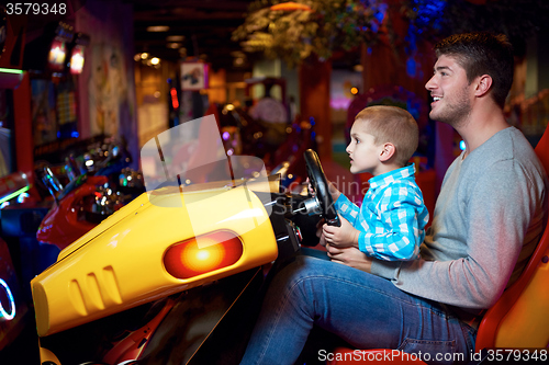 Image of father and son playing game in playground