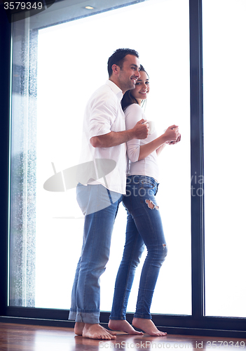 Image of relaxet young couple drink first morning coffee