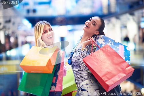 Image of happy young girls in  shopping mall