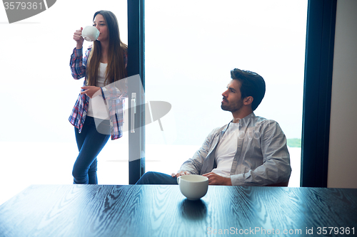 Image of relaxet young couple drink first morning coffee