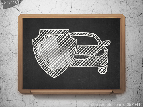 Image of Insurance concept: Car And Shield on chalkboard background