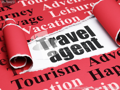 Image of Vacation concept: black text Travel Agent under the piece of  torn paper