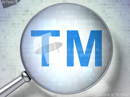 Image of Law concept: Trademark with optical glass on digital background