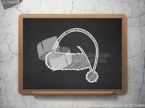 Image of Entertainment, concept: Christmas Hat on chalkboard background