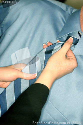 Image of Woman adjusting tie