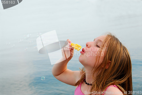 Image of Girl blowing bubbles