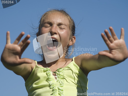Image of Girl shouting on the sky background