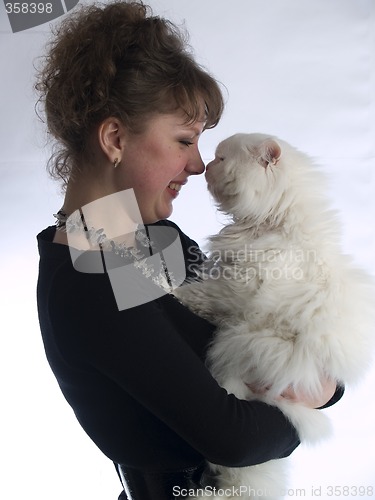 Image of Young Lady touching cat nose to nose