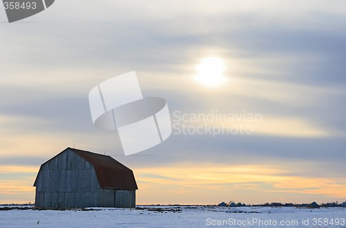 Image of Old wooden barn in a snowy field