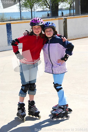 Image of Two girls rollerblading