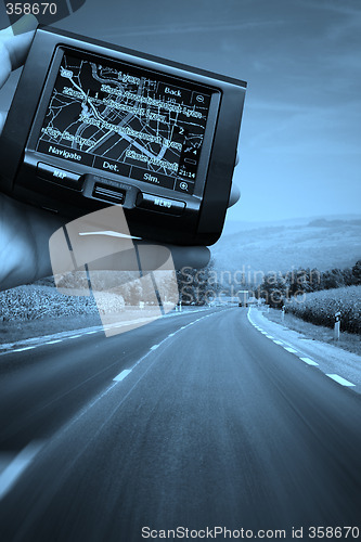 Image of GPS Vehicle navigation system in a man hand.