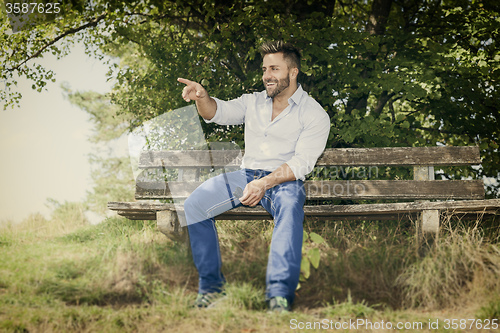 Image of man outdoors pointing