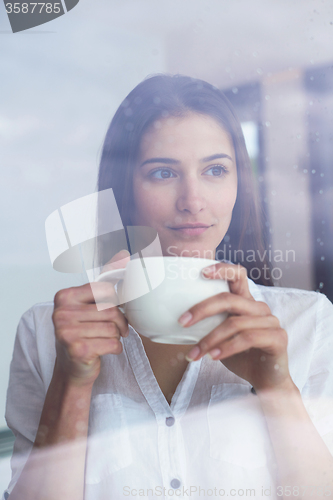 Image of beautiful young woman drink first morning coffee