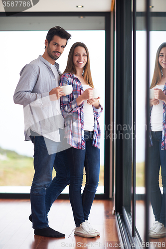 Image of relaxet young couple drink first morning coffee