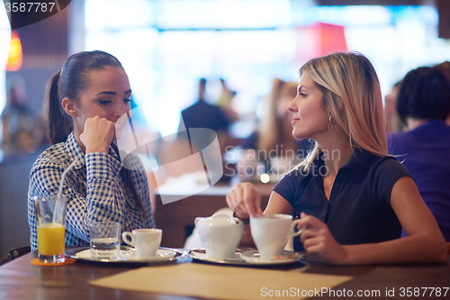 Image of girls have cup of coffee in restaurant