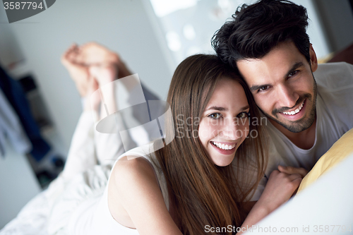 Image of couple relax and have fun in bed