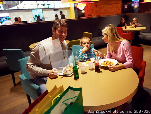 Image of family having lunch in shopping mall