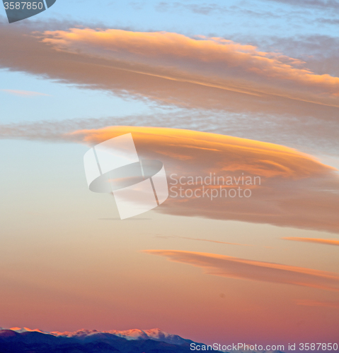 Image of sunrise in the colored sky white soft clouds and abstract backgr