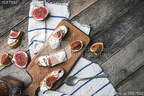 Image of rustic style Bruschetta snacks with cheese and figs