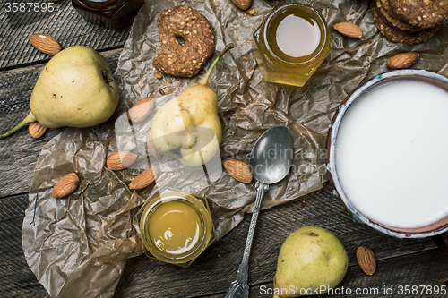 Image of pastry pears honey and yoghurt on wooden table