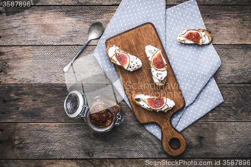 Image of rustic style tasty Bruschetta snacks with jam and figs