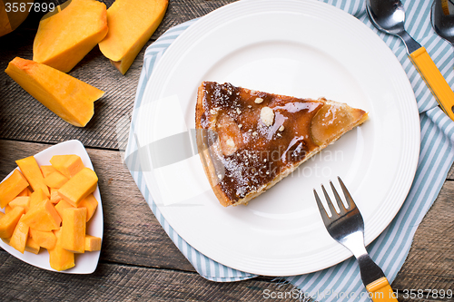 Image of Piece of pie and Pumpkin slices in Rustic style