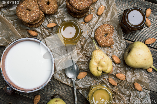 Image of Pastry pears and yoghurt on wooden table