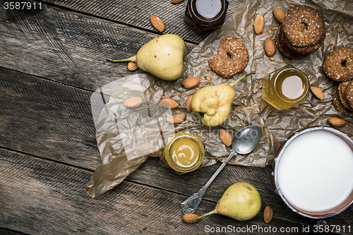 Image of Pears Cookies Almonds and milk on wood