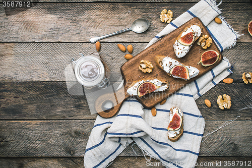 Image of Bruschetta snacks with nuts jam and figs on napkin