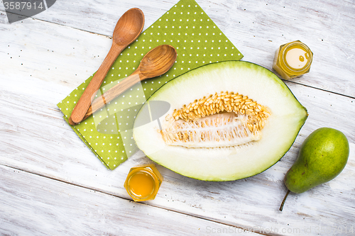 Image of Healthy melon with pear and honey on rustic board