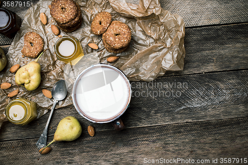 Image of  ears Cookies Almonds and milk on wood