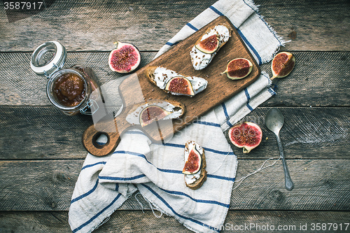 Image of rustic style Bruschetta with cheese and figs on napkin