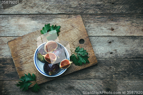 Image of Ripe Figs on board in rustic style