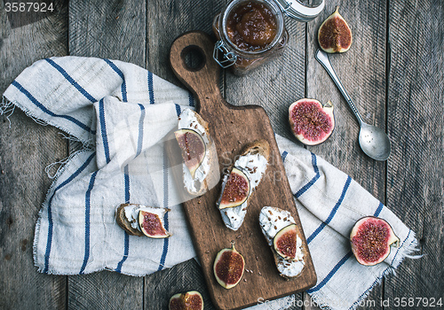 Image of rustic style tasty Bruschetta with jam and figs on napkin