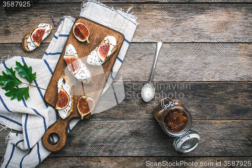 Image of Bruschetta snacks with jam and figs rustic style