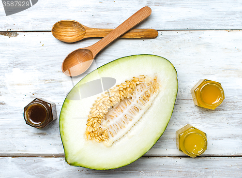 Image of Healthy melon with honey on rustic board