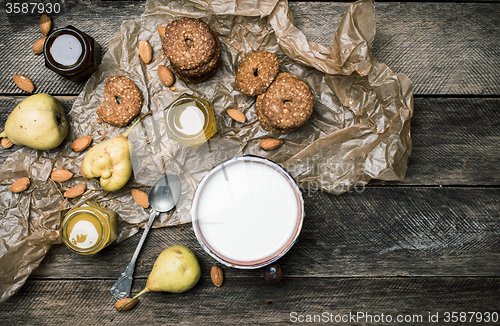 Image of Tasty Pears almonds Cookies and joghurt on rustic wood