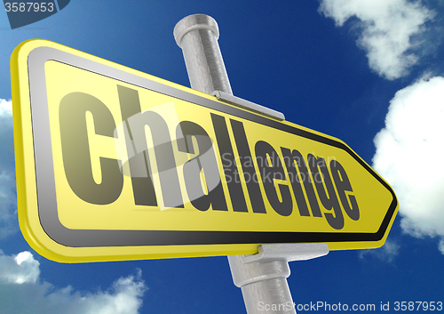 Image of Yellow road sign with challenge word under blue sky